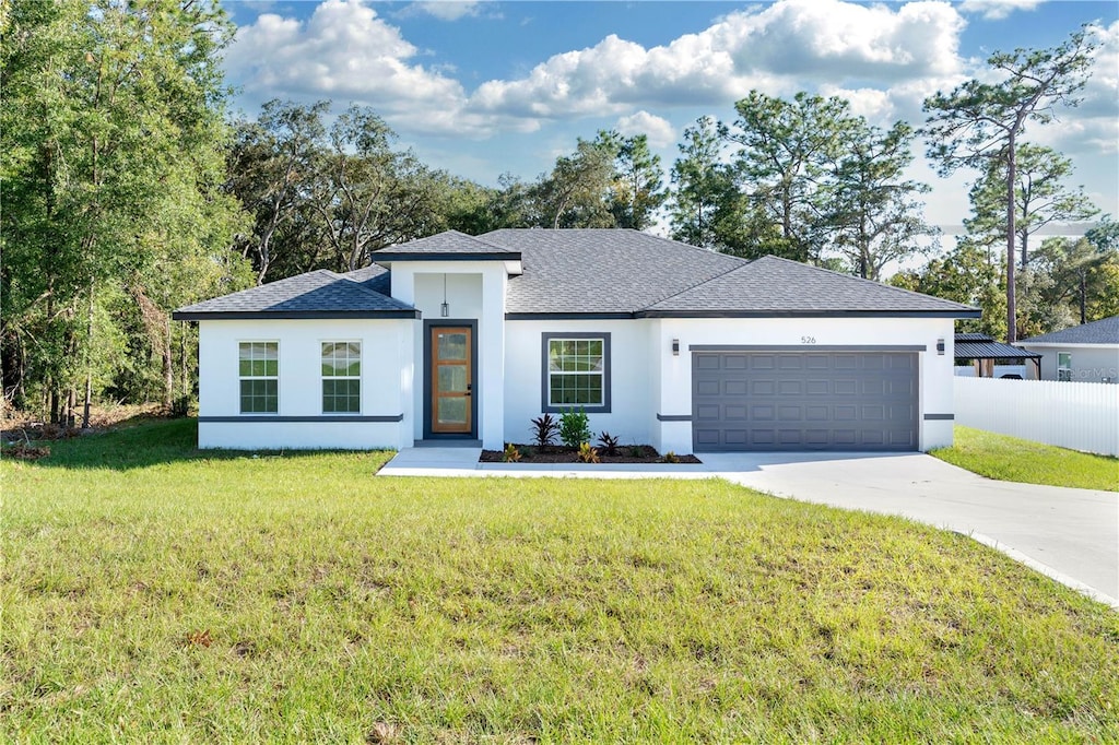 view of front facade featuring a garage and a front lawn