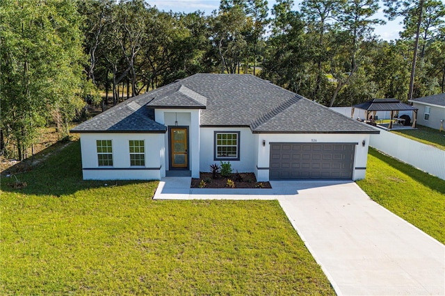 view of front of property with a front yard and a garage