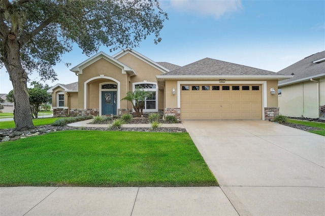 view of front of house with a garage and a front lawn