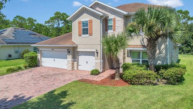 view of front of house with a front yard and a garage