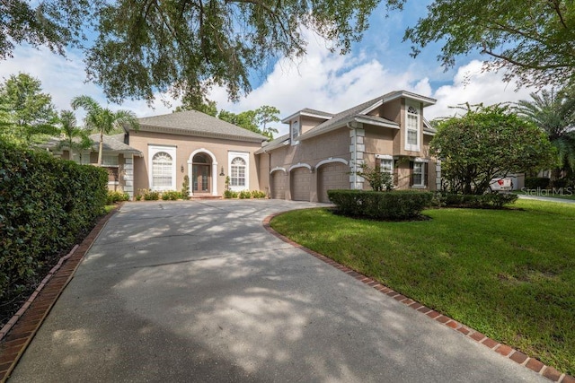 view of front of house with a garage and a front yard