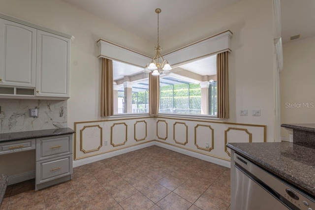 kitchen featuring dishwasher, a notable chandelier, white cabinets, decorative backsplash, and decorative light fixtures