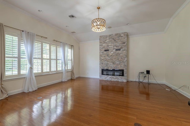 unfurnished living room featuring crown molding, hardwood / wood-style floors, and a stone fireplace