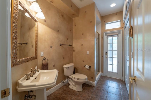 bathroom with tile patterned flooring, toilet, sink, and a shower with shower door