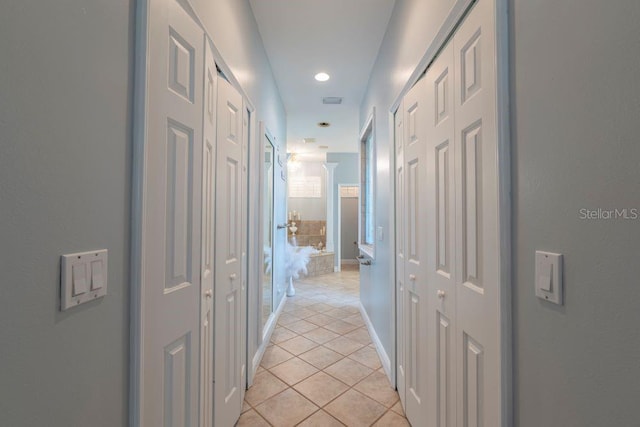 hall featuring light tile patterned floors