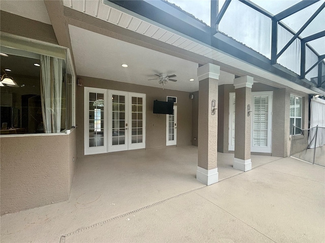 view of patio with glass enclosure and ceiling fan