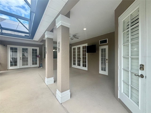 view of patio / terrace with glass enclosure, ceiling fan, and french doors