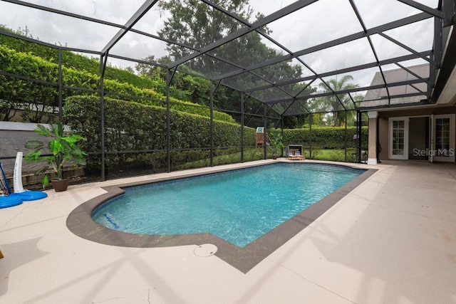 view of swimming pool with a lanai and a patio area