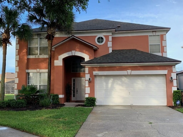 view of front of property with a garage and a front lawn