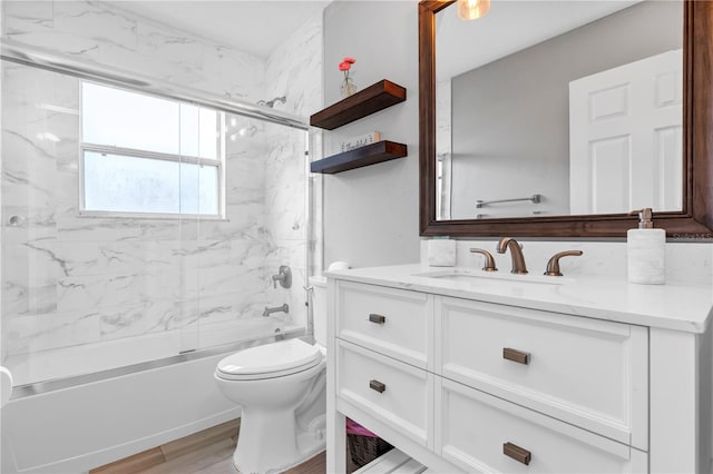 full bathroom featuring bath / shower combo with glass door, vanity, toilet, and wood-type flooring