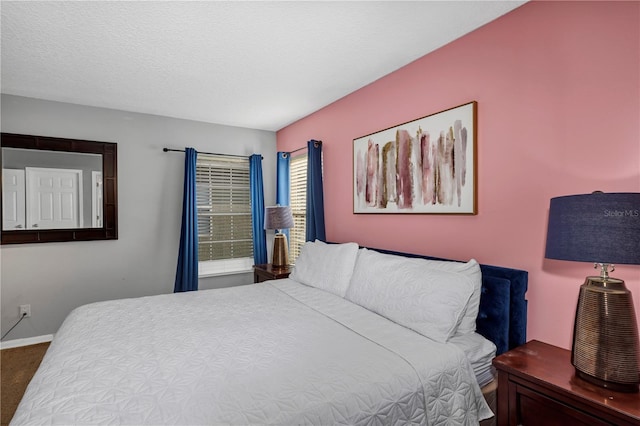 carpeted bedroom featuring a textured ceiling