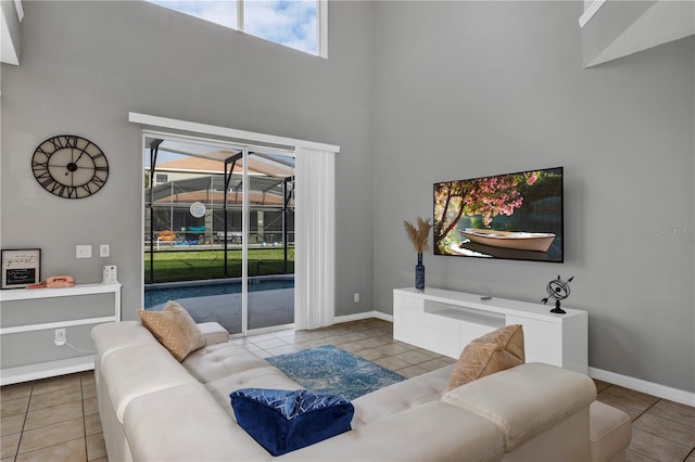 tiled living room featuring a high ceiling