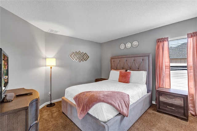 bedroom featuring carpet and a textured ceiling