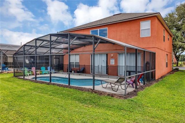 back of house featuring a patio, a lawn, and a lanai