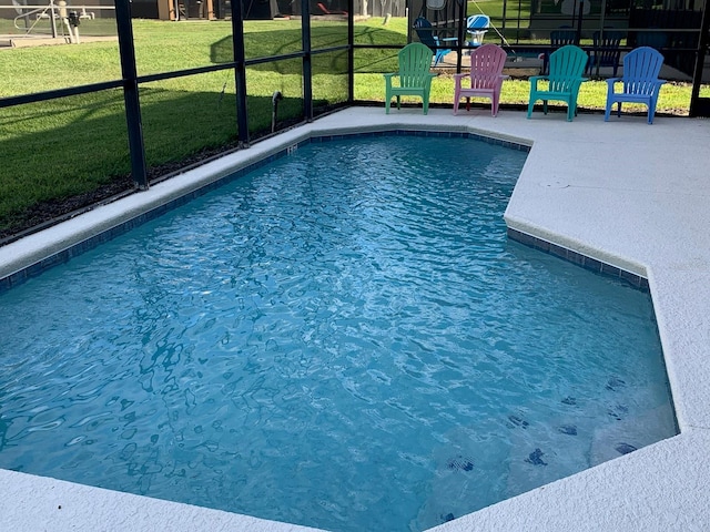 view of pool featuring a yard