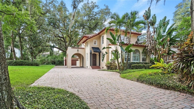 mediterranean / spanish-style home featuring a front lawn