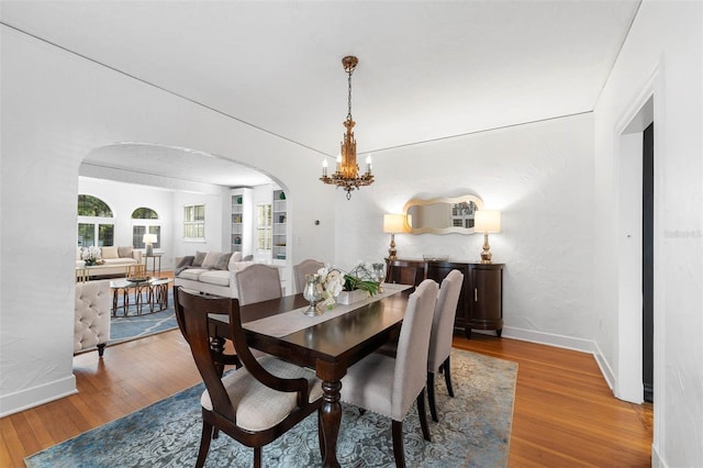 dining space featuring a chandelier and wood-type flooring