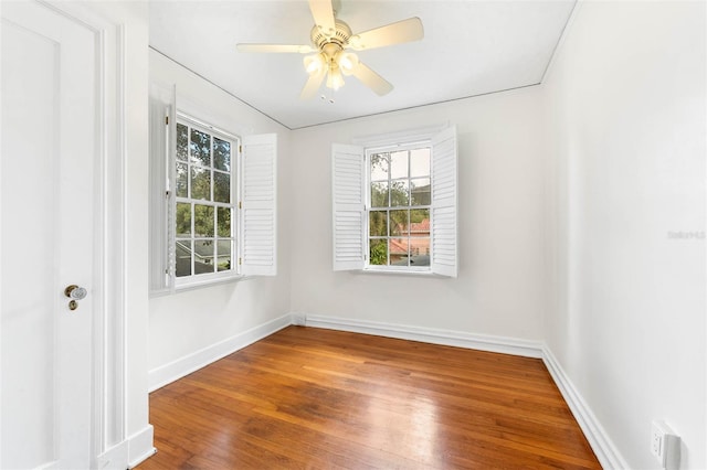 spare room featuring ceiling fan, plenty of natural light, and hardwood / wood-style floors