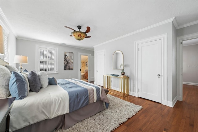 bedroom featuring dark hardwood / wood-style floors, ceiling fan, and crown molding