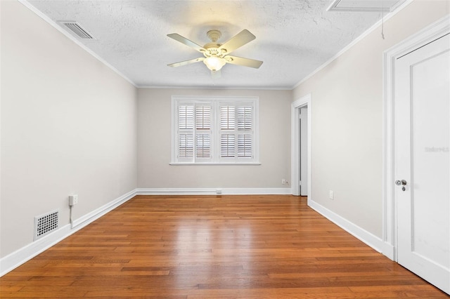 unfurnished room featuring hardwood / wood-style floors, ceiling fan, crown molding, and a textured ceiling