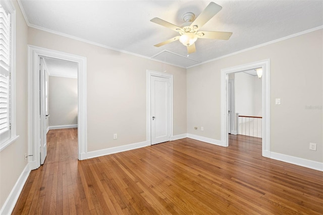 unfurnished bedroom with ceiling fan, crown molding, and wood-type flooring