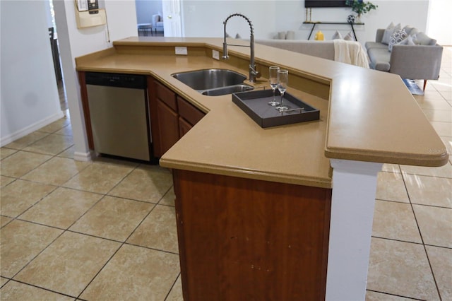 kitchen featuring kitchen peninsula, dishwasher, light tile patterned floors, and sink