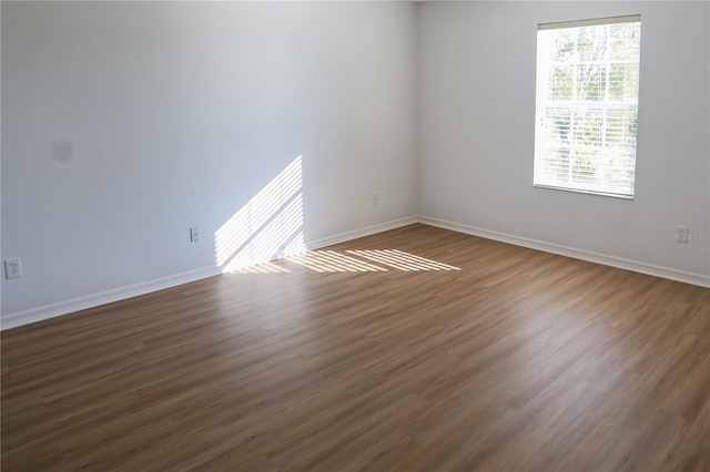 empty room featuring dark wood-type flooring