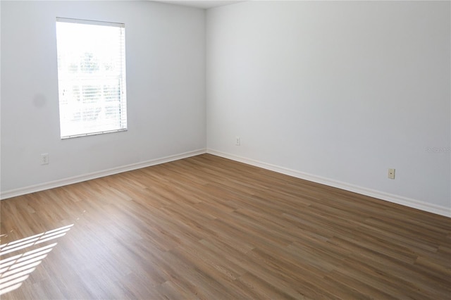 empty room with wood-type flooring