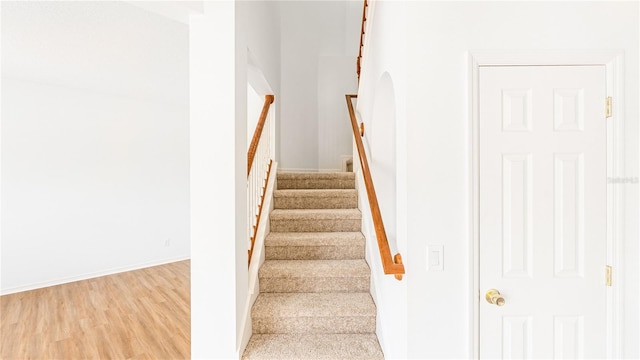 stairway featuring hardwood / wood-style flooring