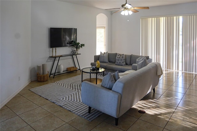 tiled living room with ceiling fan