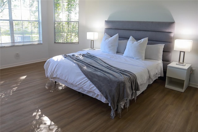 bedroom with dark wood-type flooring