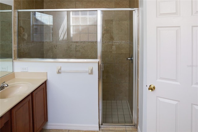 bathroom with tile patterned floors, vanity, and an enclosed shower