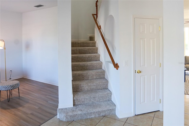 stairs with hardwood / wood-style flooring