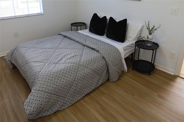 bedroom with hardwood / wood-style flooring