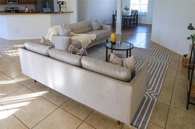 living room with tile patterned flooring and sink