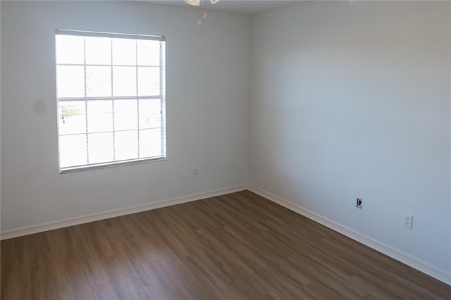 spare room featuring ceiling fan and dark wood-type flooring