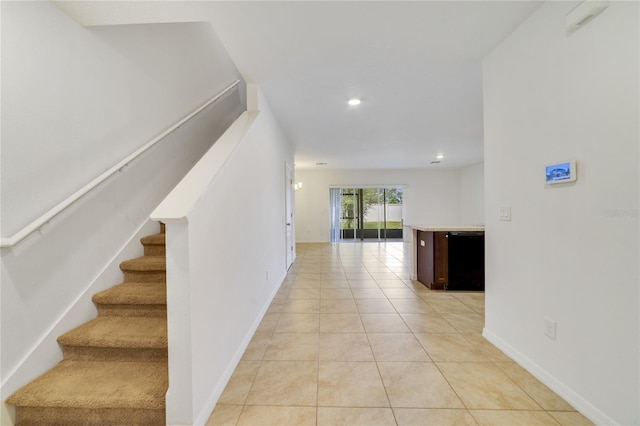 hall featuring light tile patterned floors