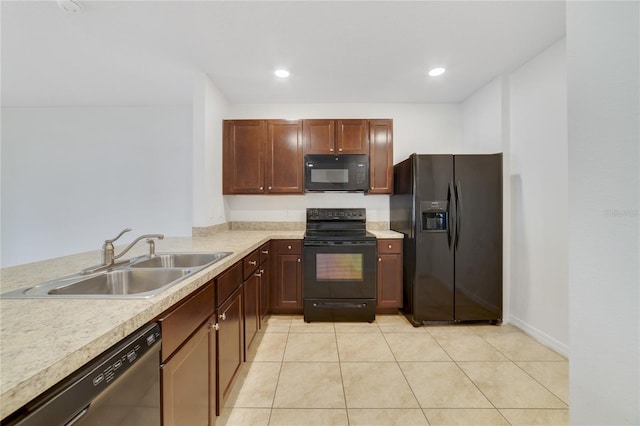 kitchen featuring black appliances, light tile patterned floors, and sink