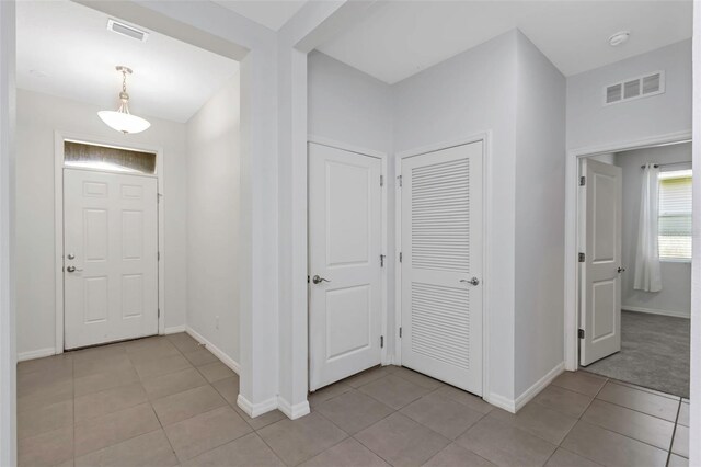 foyer entrance featuring light tile patterned floors