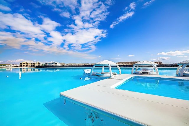 view of swimming pool featuring a water view