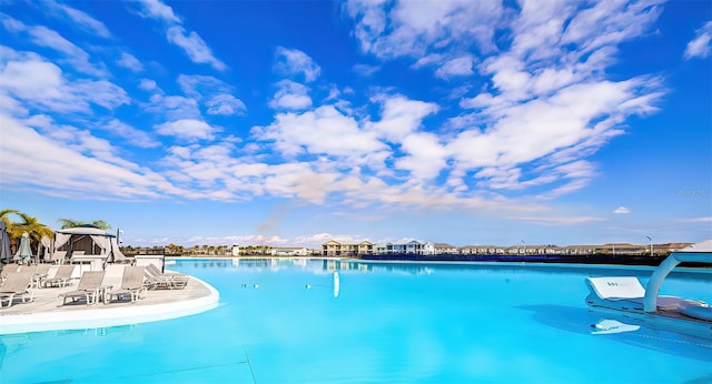 view of pool with a water view