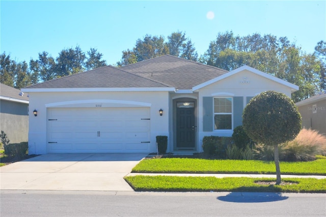 ranch-style home featuring a garage and a front lawn