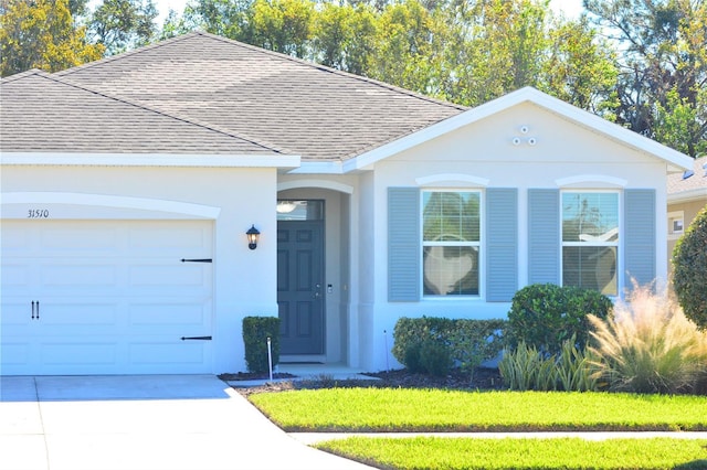 ranch-style home with a front lawn and a garage