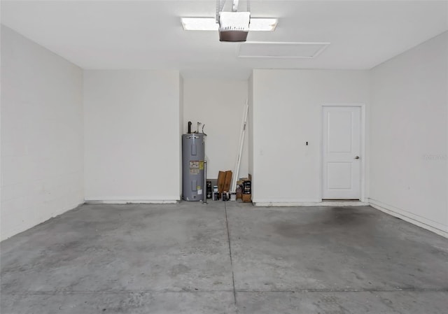 garage featuring electric water heater and a garage door opener