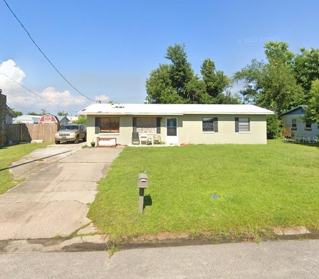 ranch-style home with a front lawn