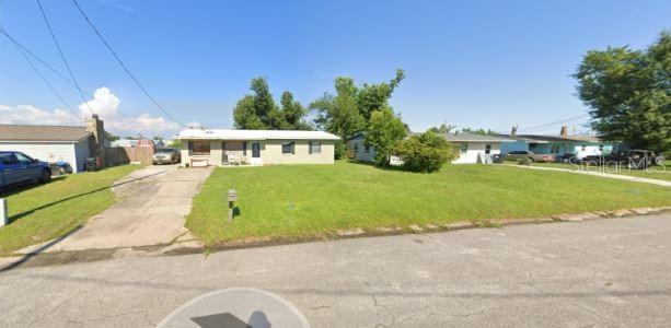 810 Forestdale Ave, Panama City, FL 32401 - ranch-style house with concrete driveway and a front yard