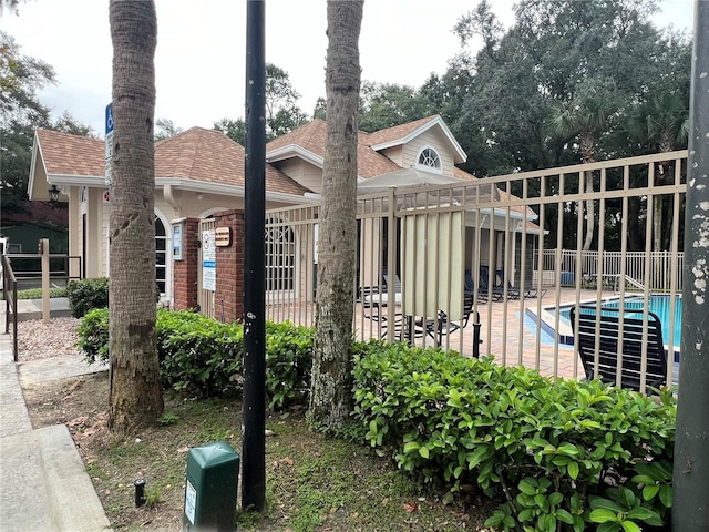 exterior space featuring fence, a fenced in pool, and a patio