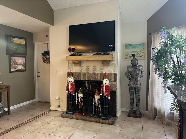 living area with tile patterned floors, baseboards, a textured ceiling, and a healthy amount of sunlight