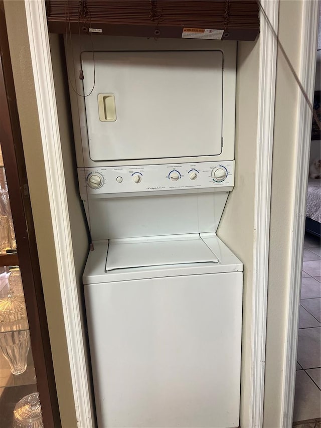 clothes washing area featuring stacked washer and dryer