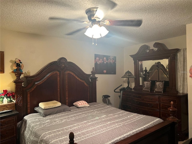 bedroom with ceiling fan and a textured ceiling